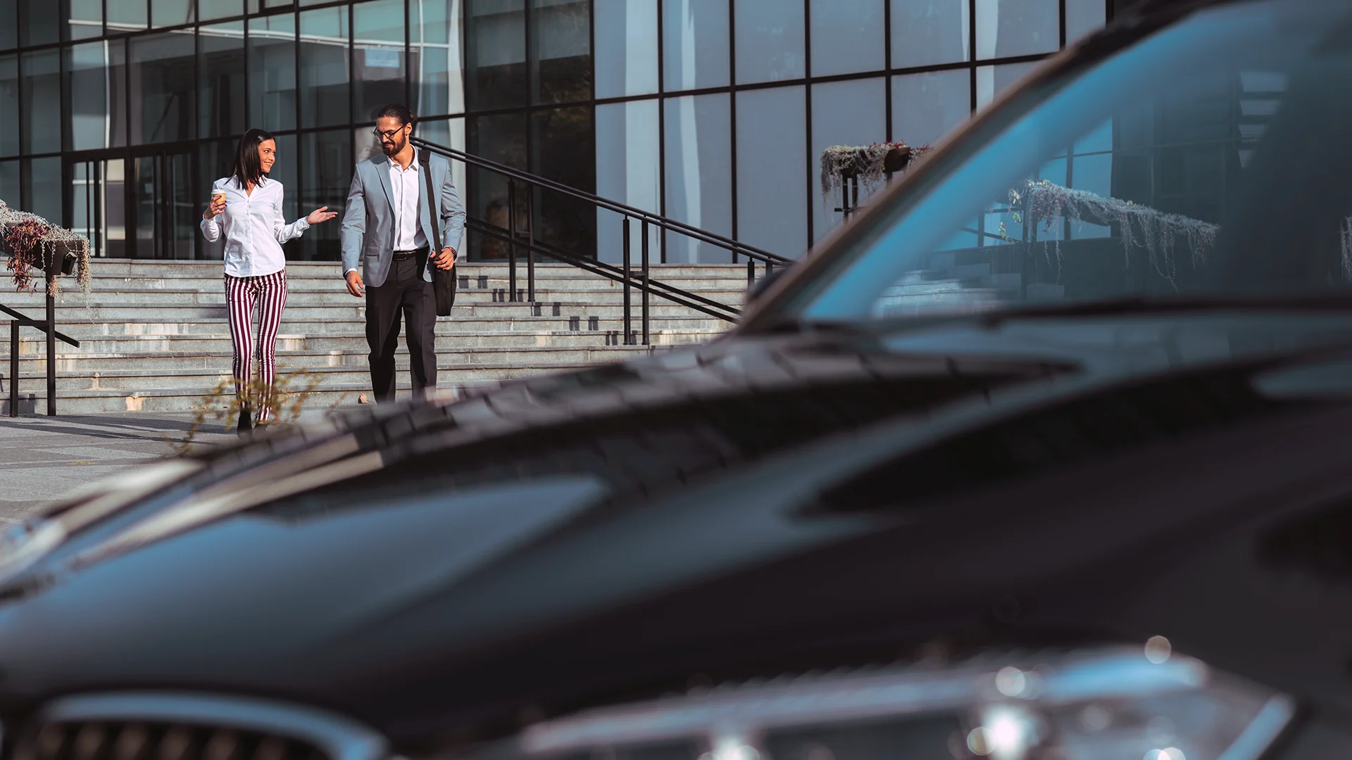 business man and woman walking to a car