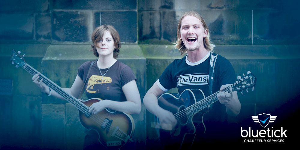 Talented street singers performing at Edinburgh Festival Fringe, harmonizing passionately for an engaged audience on the cobblestone streets.