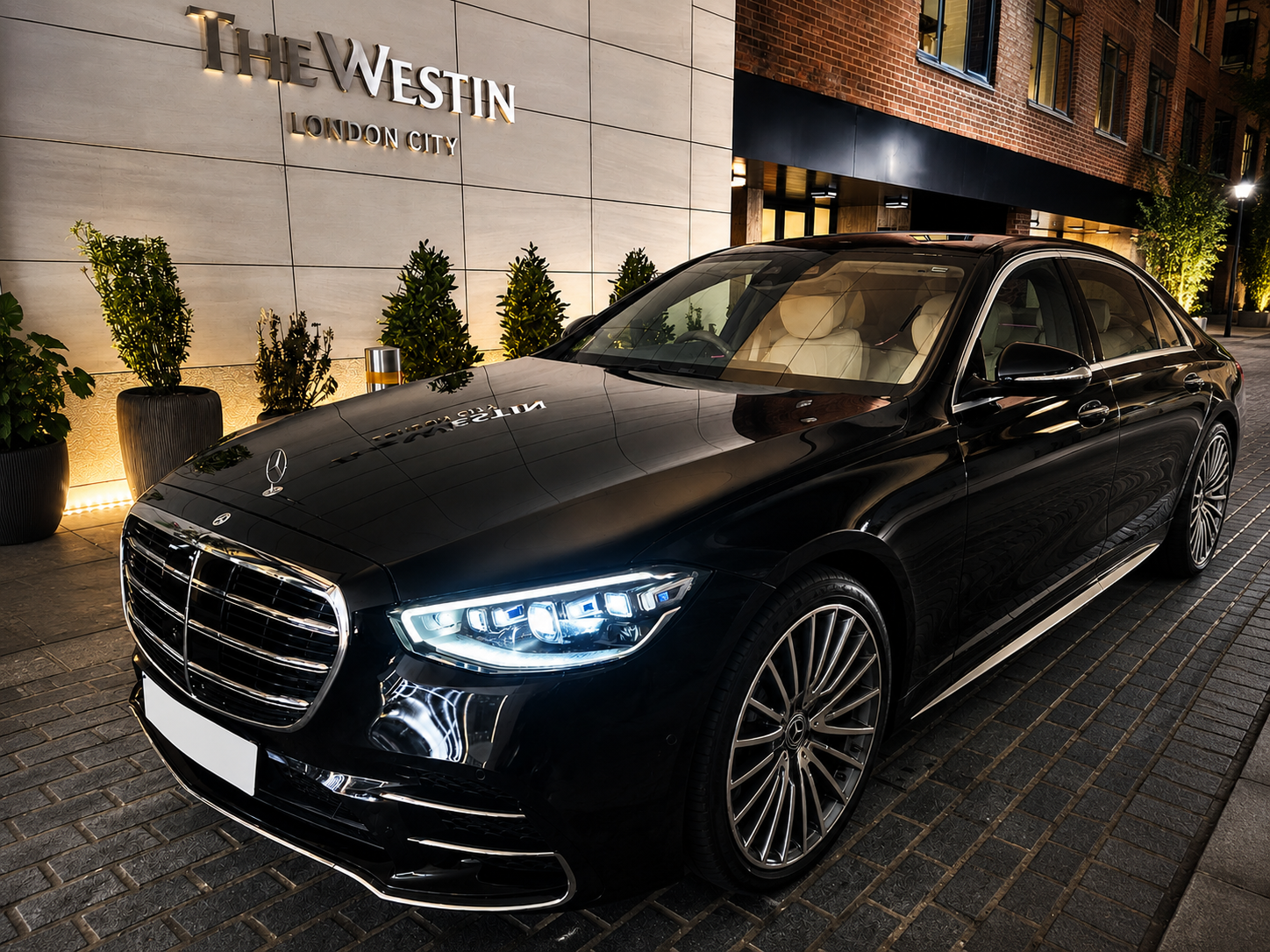 Black Mercedes S-Class chauffeur vehicle outside The Westin London City hotel