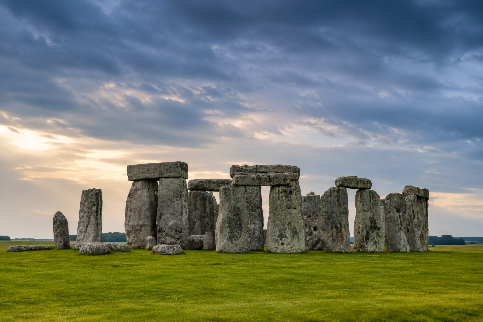 Stonehenge prehistoric stone circle on Salisbury Plain beneath a dramatic evening sky.